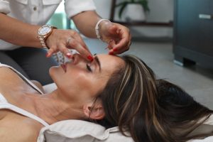 Person receiving a calming head massage as part of an Ayurvedic wellness ritual.