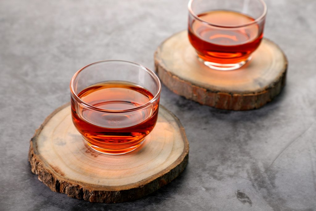 Gentle detox herbal tea served on wood coasters.