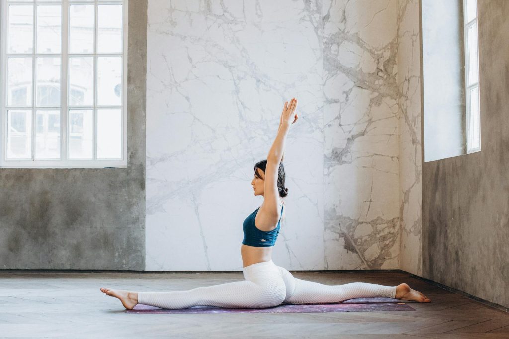 Woman in a split yoga pose representing balance and flexibility, demonstrating .