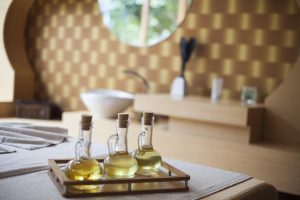 Ayurvedic Abhyanga oil guide: close-up of warm sesame oil and herbs for dosha balancing self-massage