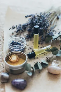 Essential oil rollers, dried lavender, and bath salts for Ayurvedic daily rituals and natural detox.