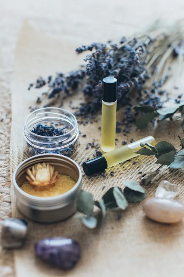 Essential oil rollers, dried lavender, and bath salts for Ayurvedic daily rituals and natural detox.